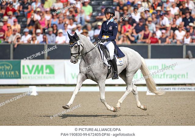 30 August 2019, Lower Saxony, Luhmühlen: Equestrian sport, eventing, European championship: The Swedish event rider Louise Romeike on Waikiki rides in the...