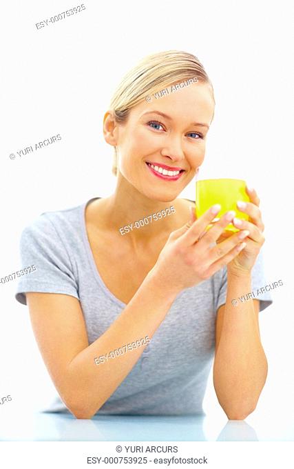 Portrait of a young woman drinking orange juice isolated over white background
