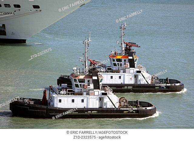 Tug boats supporting sailing of ferries from the port of Livorno Italy