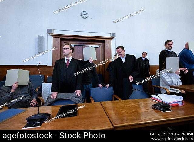 PRODUCTION - 19 December 2023, North Rhine-Westphalia, Dortmund: The five accused police officers sit between their lawyers in the courtroom of the regional...