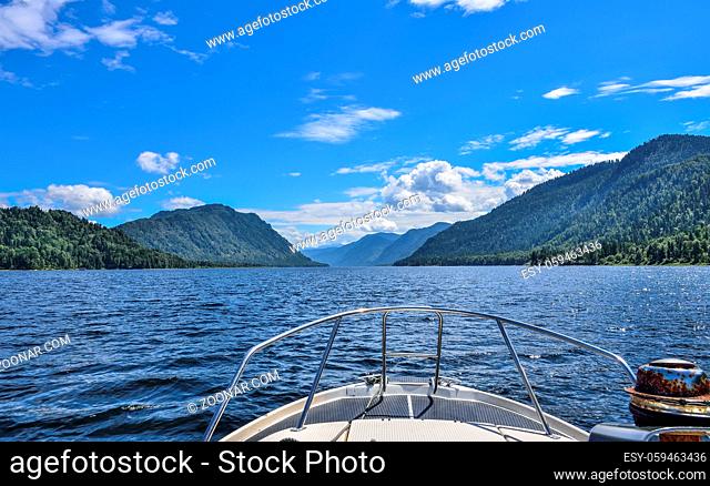 Beautiful view of Teletskoye or Golden lake and sunny mountains landscape from the boat. Russia, Altai Republic
