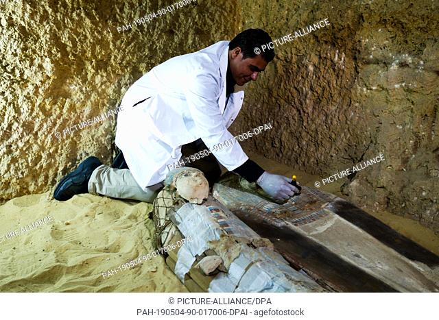 04 May 2019, Egypt, Giza: An Egyptian archaeological expert works on a newly discovered ancient limestone tomb of two priests from the fifth dynasty (about 2500...
