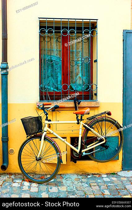 Bicycle parked near wall in Rimini, Italy
