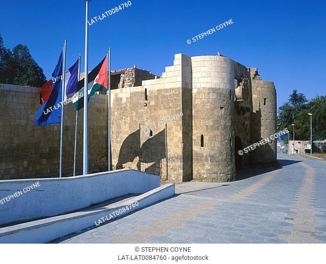 Port. Red Sea. C14th fort. Round towers, high walls. Flags