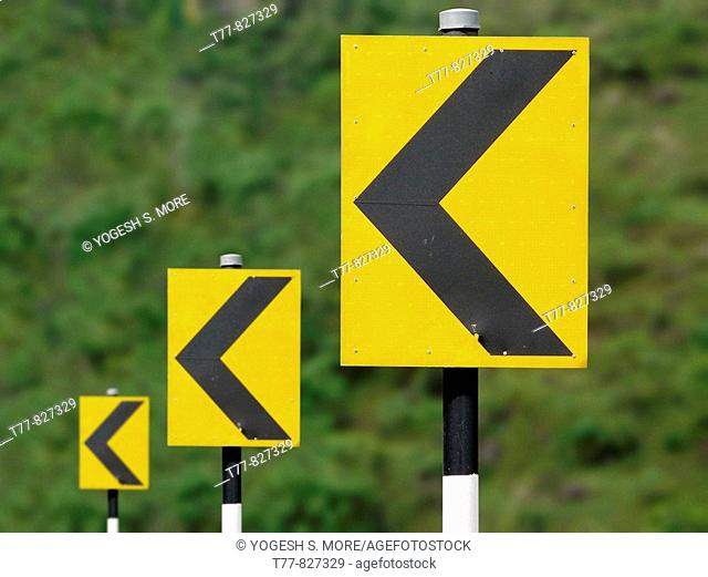 Road sign boards in sequence showing turning driving directions Katraj Bipass Highway, Pune, Maharashtra, India