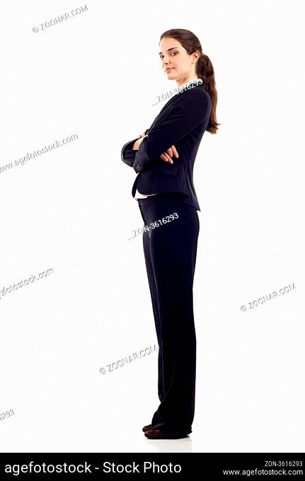 Full length, side view of a confident young business woman standing with folded hands isolated over white background