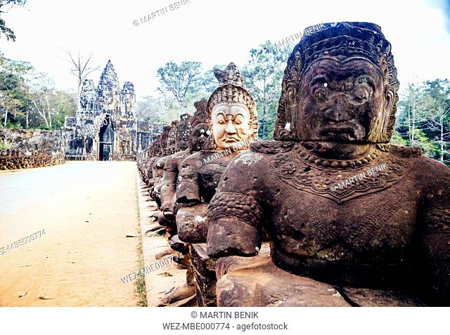 Cambodia, Siem Reap, Angkor, deamon heads on the gods and deamon bridge at the South gate of Angkor Thom