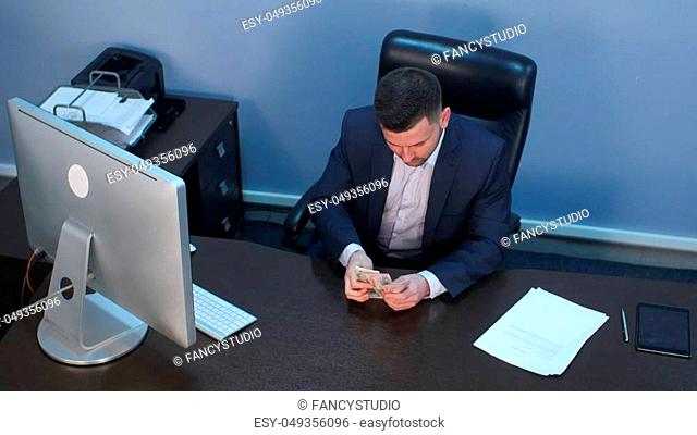 Businessman counting money dollars at the office. Top view. Professional shot in 4K resolution. 085. You can use it e. g