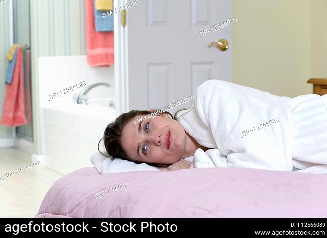 A beautiful young woman lying in bed