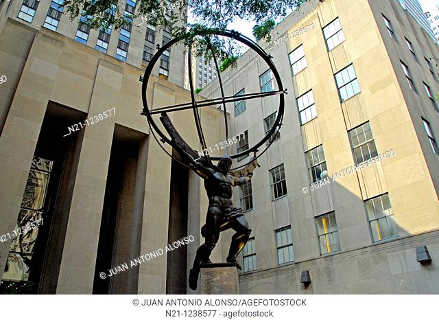 Atlas Statue in front of the Rockefeller Center.  Saint Patricks Cathedral can be seen reflected in a lower glass. Midtown East, Manhattan, New York, New York