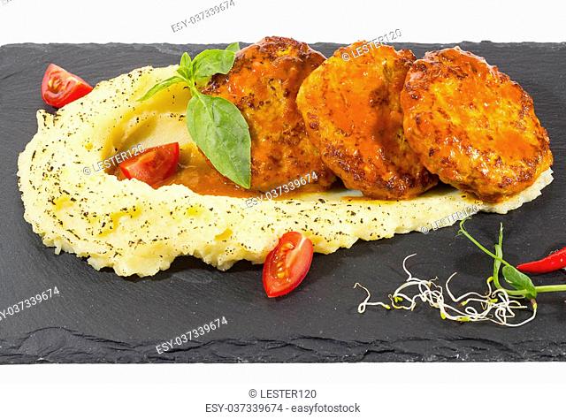 cutlets fried in carrot sauce with mashed potatoes
