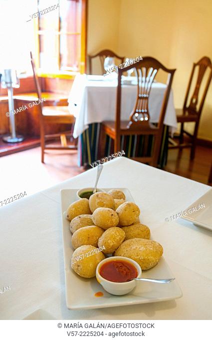 Ration of papas arrugadas with two mojo sauces in a Canarian restaurant. Madrid, Spain