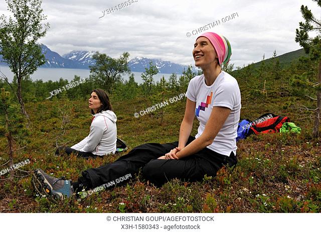 young women having a rest, Nordmannvikdalen valley, region of Lyngen, County of Troms, Norway, Northern Europe