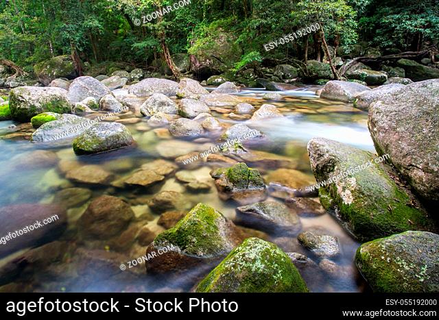Water of the Mossman River flows over ancient rocks and boulders in Mossman Gorge, Queensland, Australia