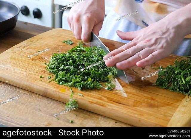 Sliced parsley and dill on a board. Greens for the second course