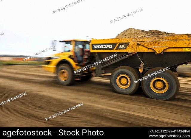 22 November 2023, Lower Saxony, Heide: A truck removes sand from a construction site in the Dithmarschen district. This is where the Northvolt battery factory...