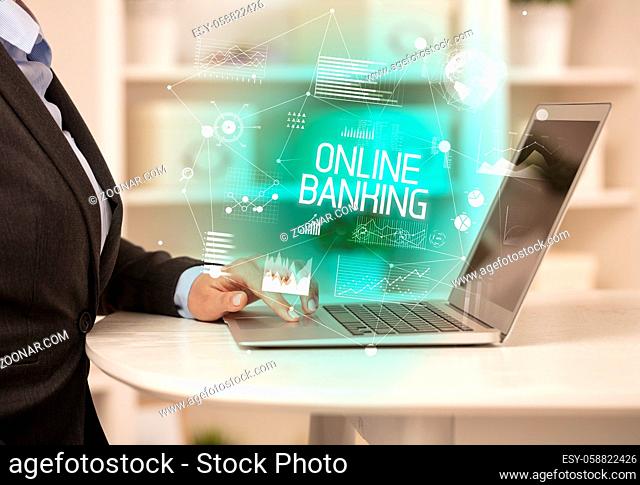 Side view of a business person working on laptop with ONLINE BANKING inscription, modern business concept