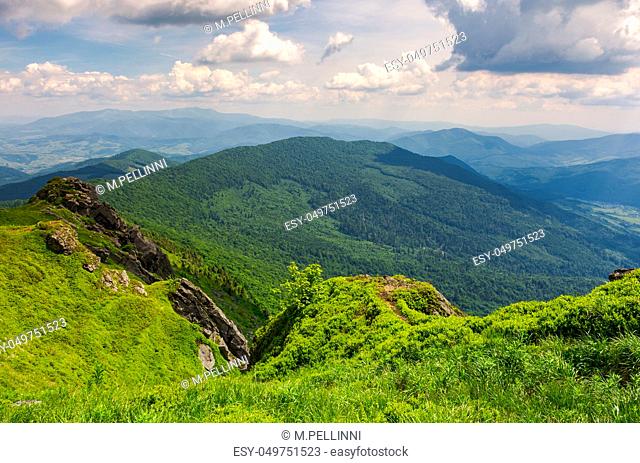 cliffs and grassy hills of Pikui mountain. beautiful view from the top. Borzhava ridge in the distance. lovely summer scenery with beautiful cloudscape