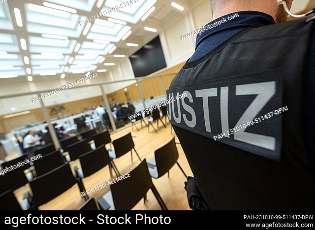 10 October 2023, Baden-Württemberg, Stuttgart: A court official stands in a room of the Stuttgart Higher Regional Court. Eleven defendants are to stand trial...