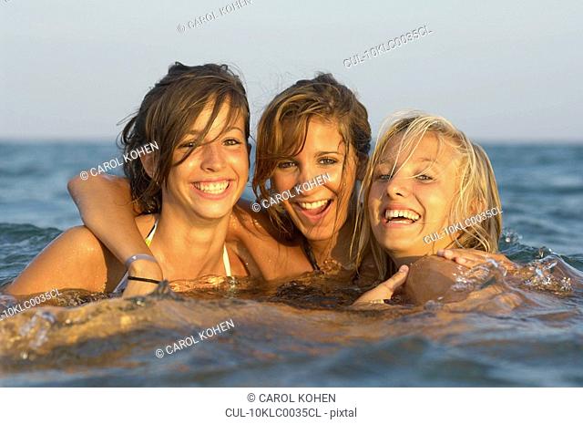 Girls teenagers playing in the sea