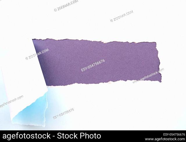 Torn pastel pastel blue paper isolated on purple