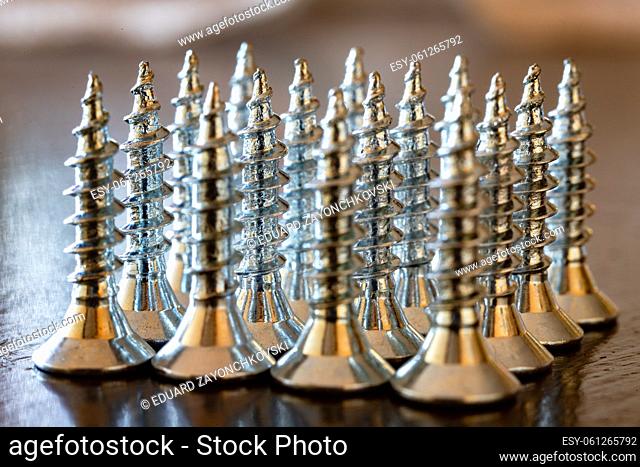 Close up of screws on a table. Advertising photo