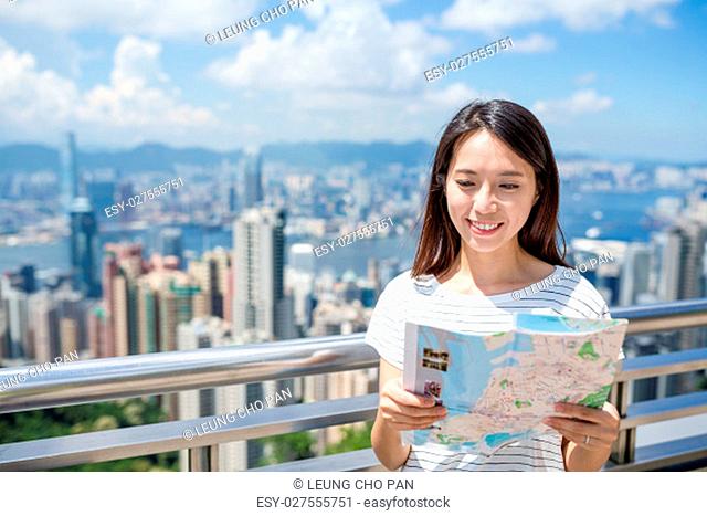 Woman checking on city map in Hong Kong city