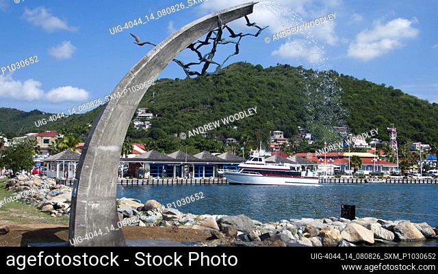 Ornamental sea bird fountain and boat at port ferry terminal Marigot French Saint Martin