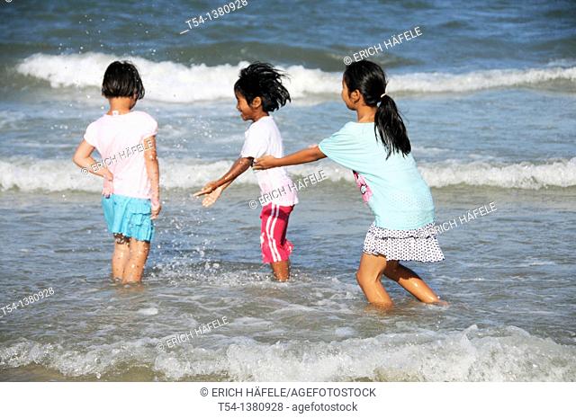 Thai children playing on the beach in Hua Hin