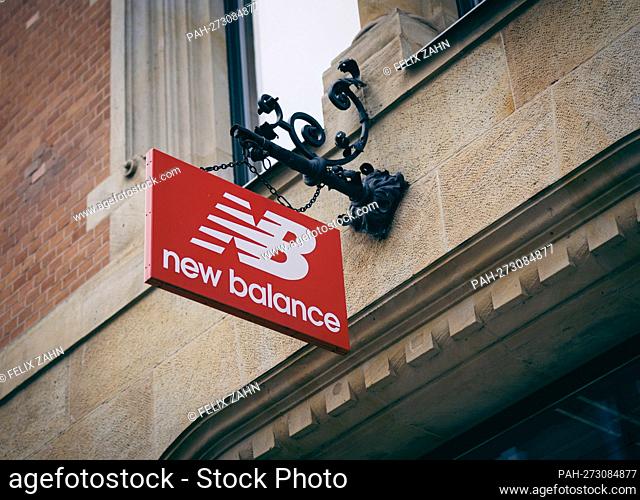 A sign from the company New Balance hangs over a shop in Berlin. 02/02/2022. - Berlin/Deutschland