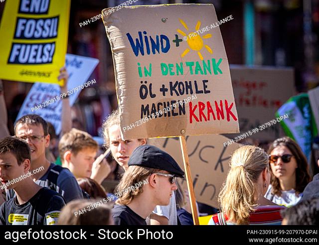 15 September 2023, Mecklenburg-Western Pomerania, Schwerin: A participant of a demonstration of the climate protection movement Fridays for Future carries a...