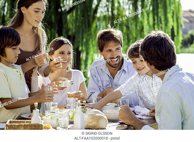 Family enjoying breakfast together outdoors