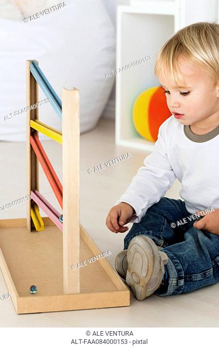 Baby playing with marble rolling game