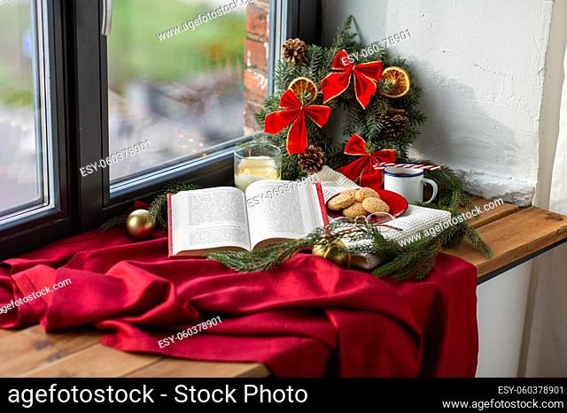 book, cookies, cup of coffee and christmas decor