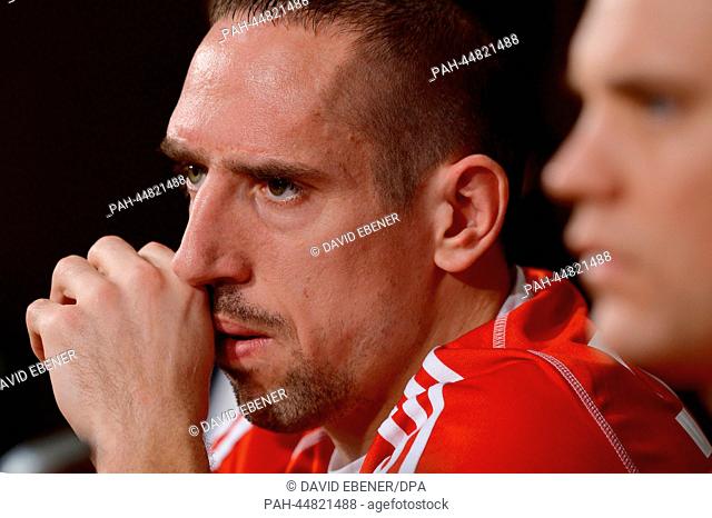 Bayern Munich's goalkeeper Manuel Neuer (R) and Franck Ribery speak during a press conference at the 'Stade Adrar' stadium following a practice session of...