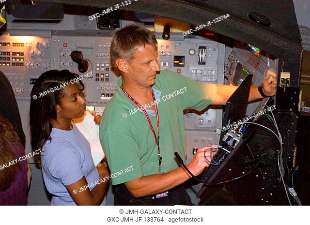 Astronauts Stephanie D. Wilson and Piers J. Sellers, both STS-121 mission specialists, participate in an exercise in the systems engineering simulator at the...