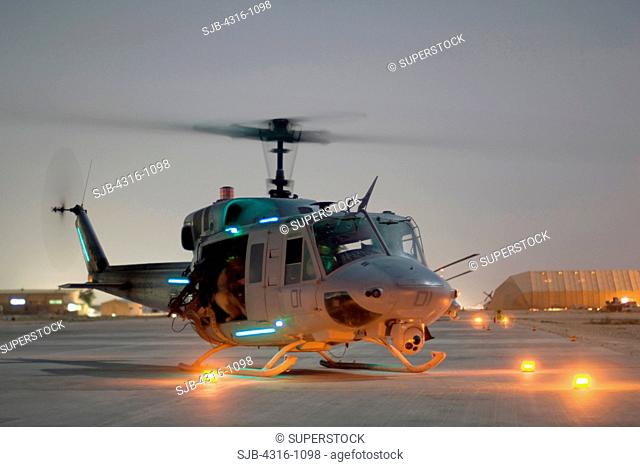 A US Marine Corps UH-1N Iroquois Prepares to Launch For a Nighttime Close Air Support Mission At Al Asad Air Base in the Al Anbar Province of Iraq
