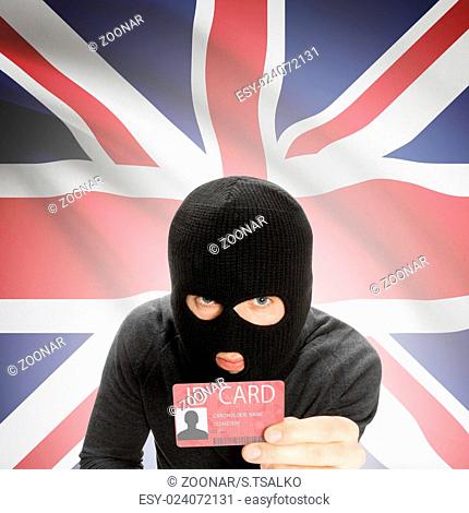 Hacker with flag on background holding ID card in hand - United Kingdom