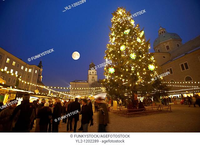 Christmas market stalls and Christmas tree at night at Satlzburgh market - Austria