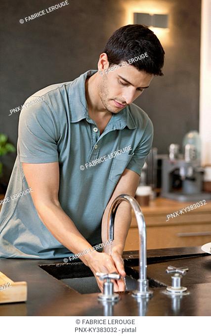 Man washing hands in the kitchen