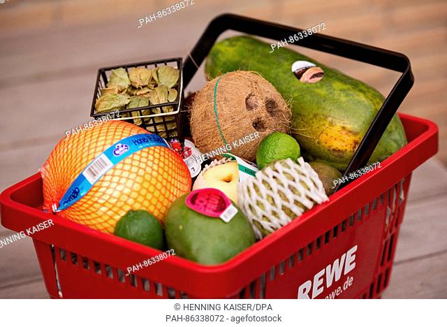 A mango, nashi pear, physalis, pomelo, cherimoya, coconut and other varieties of exotic fruit seen in a shopping basket in Cologne, Germany, 07 December 2016