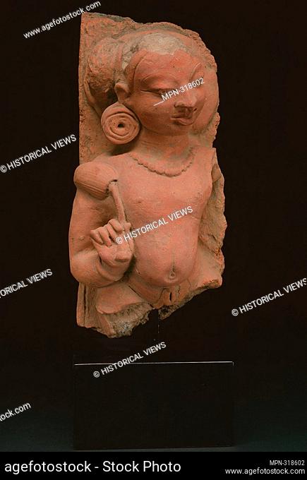 Male Deity (Deva) Holding a Lotus Bud - Gupta period, 4th/5th century - India Uttar Pradesh. Terracotta. 301 AD - 500 AD
