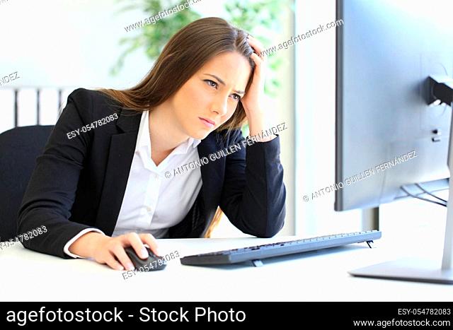 Worried businesswoman checking computer online content at office