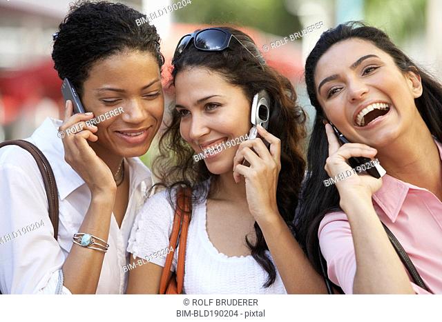 Multi-ethnic women talking on cell phones