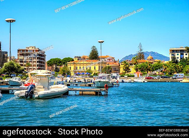 Olbia, Sardinia / Italy - 2019/07/21: Panoramic view of Olbia port and yacht marina shore area with Citi hall - Municipio di Olbia - and Piazza Terranova...