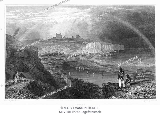 A view over Dover showing the Castle, the white cliffs and harbour beneath a rainbow