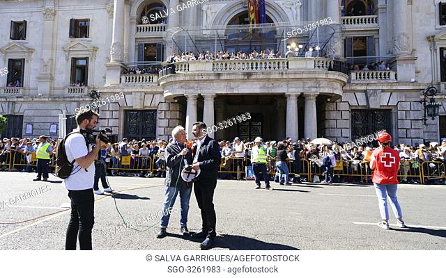 Thousands of people gather around the square to see and hear the Mascletà in the Town Hall Square of Valencia, Spain