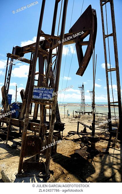 Azerbaijan, Baku, Bibi Heybat, nodding donkey oil pumps pumping oil up from an oil field