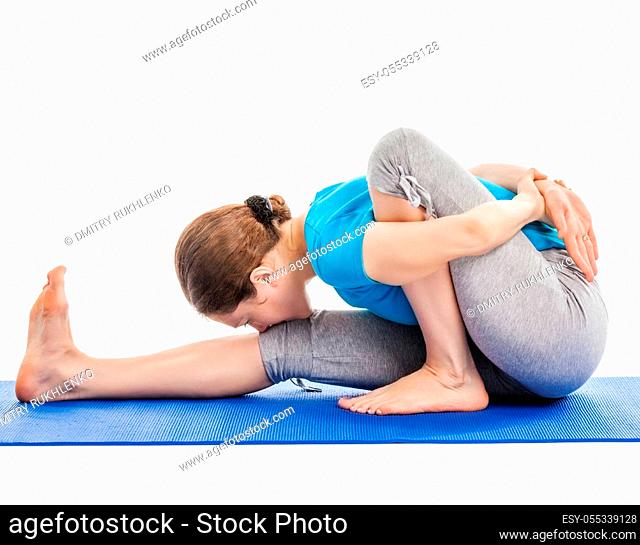 Yoga - young beautiful slender woman yoga instructor doing Forward Bends Sage Twist A pose (Marichyasana A) asana exercise isolated on white background