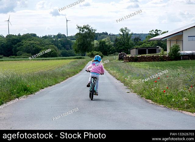 Bamberg, Germany May 26th, 2020: Symbolic images - 2020 child is riding a bicycle / child is wearing a helmet while cycling / child is riding a bicycle on the...